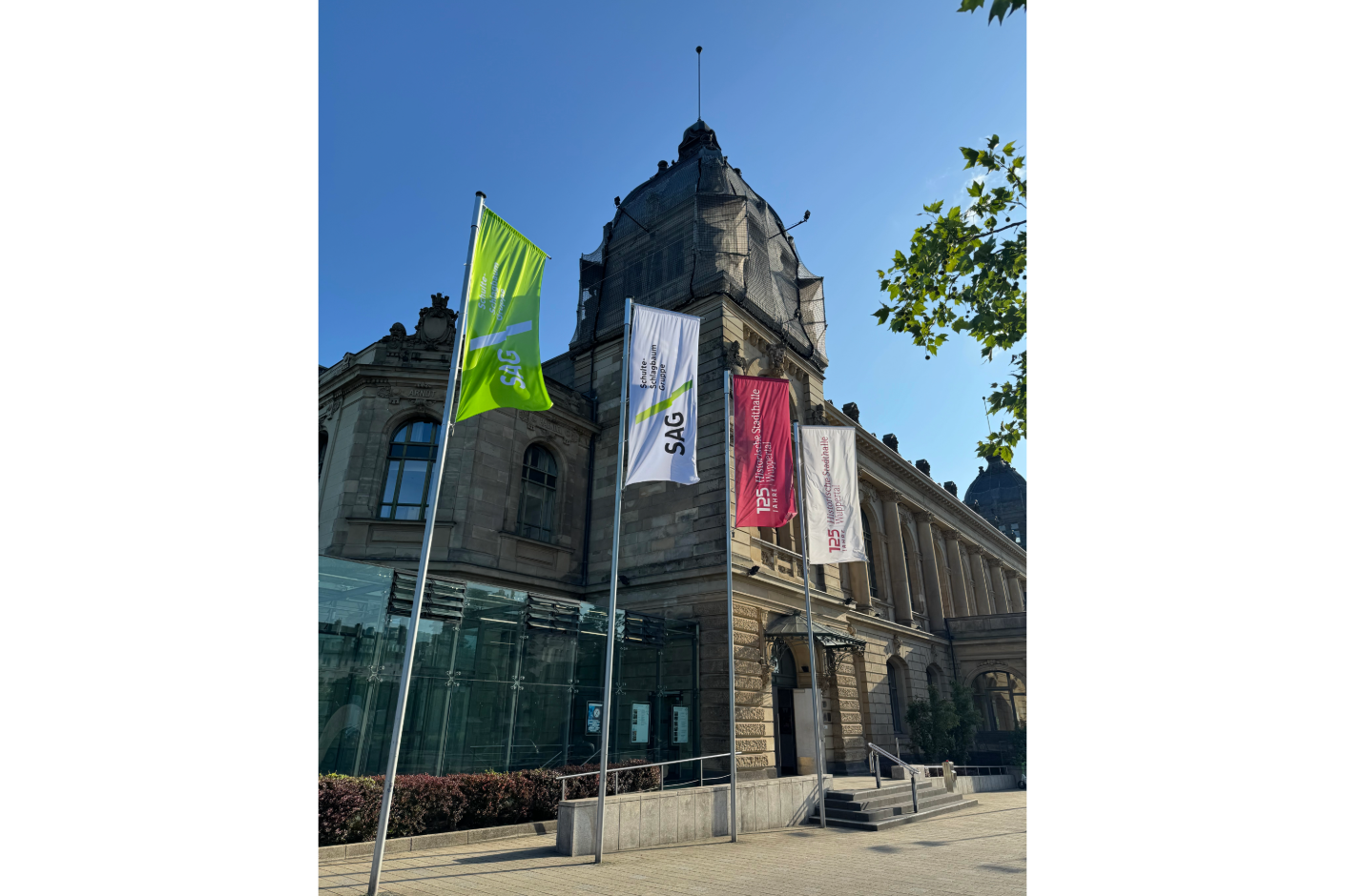 Foto von der Wuppertaler Stadthalle, im Vordergrund 4 Flaggen mit den Logos der Eccos Pro und der Schulte Schlagbaum AG